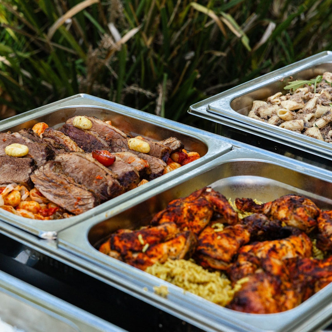 Prepared meals in metal containers outdoors
