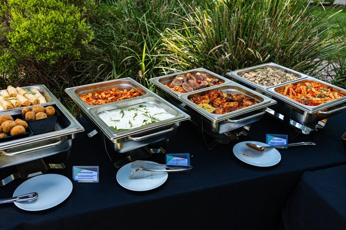 Outdoor buffet setup with various dishes on a table